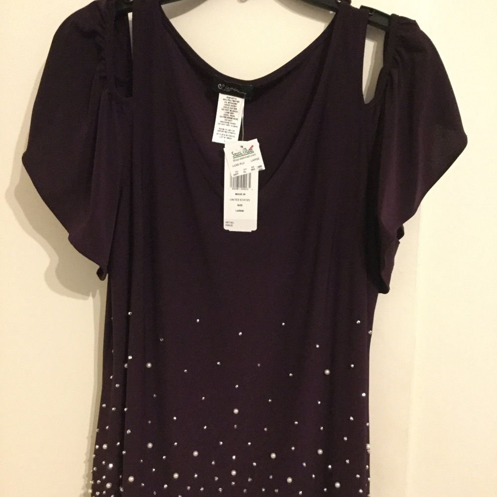 A  plum colored cold shoulder evening blouse